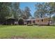 Beautiful backyard with mature trees and partial view of the home at 112 Pioneer Trail, Cartersville, GA 30121