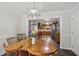 Dining room adjacent to kitchen featuring wood floors, natural light and access to the kitchen at 112 Pioneer Trail, Cartersville, GA 30121