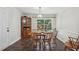 Charming dining room with wood table, chairs, and a window overlooking the backyard at 112 Pioneer Trail, Cartersville, GA 30121