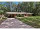 Well-maintained home with a long driveway, attached carport, and a storage shed in the backyard at 112 Pioneer Trail, Cartersville, GA 30121