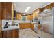 Traditional kitchen with stainless steel appliances, wood cabinets, and tiled backsplash at 112 Pioneer Trail, Cartersville, GA 30121