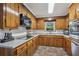 Charming kitchen with wooden cabinetry, tile backsplash and modern appliances offer ample workspace at 112 Pioneer Trail, Cartersville, GA 30121