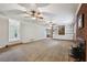 Open-concept living area with brick fireplace, carpet floors, and ceiling fans creates a cozy atmosphere at 112 Pioneer Trail, Cartersville, GA 30121