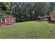 Spacious backyard featuring large shed and screened-in porch at 112 Pioneer Trail, Cartersville, GA 30121
