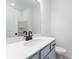 Modern bathroom with a sleek white vanity and fixtures at 1725 Lansmere Sw St, Marietta, GA 30008