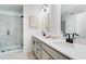 Modern bathroom featuring double vanity, large mirror, and glass-enclosed shower at 1725 Lansmere Sw St, Marietta, GA 30008