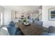 Bright dining area features wood table, pendant lighting, and connects seamlessly to the modern white kitchen at 1725 Lansmere Sw St, Marietta, GA 30008