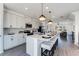 Modern kitchen with white cabinetry, stainless steel appliances, quartz countertops, and island with barstool seating at 1725 Lansmere Sw St, Marietta, GA 30008