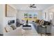 Bright living room with a fireplace, large windows, comfortable seating, and stylish decor at 1725 Lansmere Sw St, Marietta, GA 30008