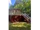 Back deck with stairs and white railing overlooking green foliage at 2030 Carr Rd, Conyers, GA 30012
