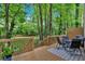 Enjoy this lovely outdoor living space with a wood deck, dining table, and backyard views at 2766 Stonecreek Se Rd, Smyrna, GA 30080