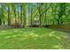 Large, grassy backyard with mature trees and privacy fence is perfect for play and relaxation at 2766 Stonecreek Se Rd, Smyrna, GA 30080