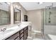 Bright bathroom featuring double sinks, modern fixtures, a soaking tub, and a large glass-enclosed shower at 2766 Stonecreek Se Rd, Smyrna, GA 30080