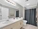 This bathroom has dual sinks and a shower curtain at 2766 Stonecreek Se Rd, Smyrna, GA 30080
