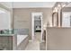 This bathroom features a soaking tub and a window leading to the Primary bedroom at 2766 Stonecreek Se Rd, Smyrna, GA 30080
