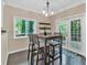 Bright breakfast nook features a modern light fixture, a view to the rear deck, and stylish decor at 2766 Stonecreek Se Rd, Smyrna, GA 30080
