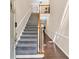 A foyer with grey carpet on the stairs and wood flooring, leading to an upper level at 2766 Stonecreek Se Rd, Smyrna, GA 30080