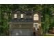 Charming two-story home features a brick facade, arched window, and a two-car garage nestled among mature trees at 2766 Stonecreek Se Rd, Smyrna, GA 30080