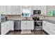 Lovely kitchen featuring white cabinets, stainless steel appliances, and granite countertops at 2766 Stonecreek Se Rd, Smyrna, GA 30080