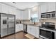 Lovely kitchen featuring white cabinets, stainless steel appliances, and granite countertops at 2766 Stonecreek Se Rd, Smyrna, GA 30080