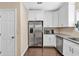 Lovely kitchen featuring white cabinets, stainless steel appliances, and granite countertops at 2766 Stonecreek Se Rd, Smyrna, GA 30080