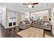 Comfortable living room featuring hardwood floors, a ceiling fan, and a large gray sectional sofa at 2766 Stonecreek Se Rd, Smyrna, GA 30080