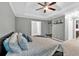 This is a view of the main bedroom showcasing a seating area, tray ceiling, and an en-suite bathroom at 2766 Stonecreek Se Rd, Smyrna, GA 30080