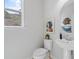 Powder room with a modern pedestal sink, round mirror, and stylish decor at 3142 Washburn St, Atlanta, GA 30354