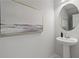 Powder room with modern pedestal sink and artistic accents at 3142 Washburn St, Atlanta, GA 30354