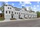 Long row of contemporary townhomes, each with a garage, set against a green landscape and blue sky at 3142 Washburn St, Atlanta, GA 30354