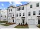 Attractive three-story townhome with white siding, black accents, and well-manicured front lawn at 3142 Washburn St, Atlanta, GA 30354