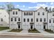 Charming three-story townhomes featuring attached garages, manicured lawns, and crisp white siding at 3142 Washburn St, Atlanta, GA 30354