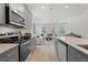 Modern kitchen with stainless steel appliances and open view to a bright living space at 3142 Washburn St, Atlanta, GA 30354