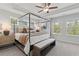 Elegant main bedroom featuring a four-poster bed, tray ceiling, and natural light at 3142 Washburn St, Atlanta, GA 30354