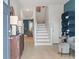 Inviting foyer with wood floors, staircase, and stylish decor in a modern townhome at 324 Navigator Ln, Mcdonough, GA 30253