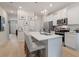 Modern kitchen with white cabinetry, stainless steel appliances, and a spacious island with bar seating at 324 Navigator Ln, Mcdonough, GA 30253