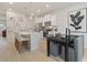 Bright kitchen featuring white cabinets, stainless steel appliances, and a cozy dining area at 324 Navigator Ln, Mcdonough, GA 30253