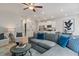 Cozy living room with a gray sectional couch, modern decor, and an open view to the kitchen at 324 Navigator Ln, Mcdonough, GA 30253