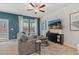 Bright living room with a comfortable sofa, ceiling fan, and modern decor at 324 Navigator Ln, Mcdonough, GA 30253