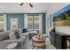 Stylish living room featuring a comfortable sectional, ceiling fan, and contemporary decor at 324 Navigator Ln, Mcdonough, GA 30253