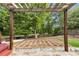 Backyard featuring a pergola, a patio, and a wooded area at 355 Pintail Ct, Suwanee, GA 30024