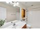 Clean bathroom featuring a tub/shower combo, a large mirror, and neutral walls at 355 Pintail Ct, Suwanee, GA 30024