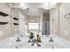 Bright bathroom featuring double sinks, a soaking tub, and a separate shower area at 355 Pintail Ct, Suwanee, GA 30024