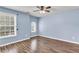 Bedroom with hardwood floors and lots of natural light coming from several windows at 355 Pintail Ct, Suwanee, GA 30024