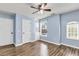 Bedroom with hardwood floors, built-in shelves and cabinets, neutral walls and bright natural light at 355 Pintail Ct, Suwanee, GA 30024