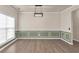 Spacious dining room with modern light fixture, decorative wainscoting, and hardwood floors at 355 Pintail Ct, Suwanee, GA 30024