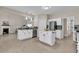Spacious kitchen with an island, stainless steel appliances, and seamless flow to the living area at 355 Pintail Ct, Suwanee, GA 30024