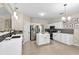 Modern kitchen featuring white cabinets, stainless steel appliances and a kitchen island at 355 Pintail Ct, Suwanee, GA 30024