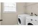 Bright laundry room with a front-load washer and dryer, offering convenience and efficiency at 355 Pintail Ct, Suwanee, GA 30024