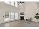 Bright living room boasts high ceilings, fireplace, hardwood floors, and large windows at 355 Pintail Ct, Suwanee, GA 30024
